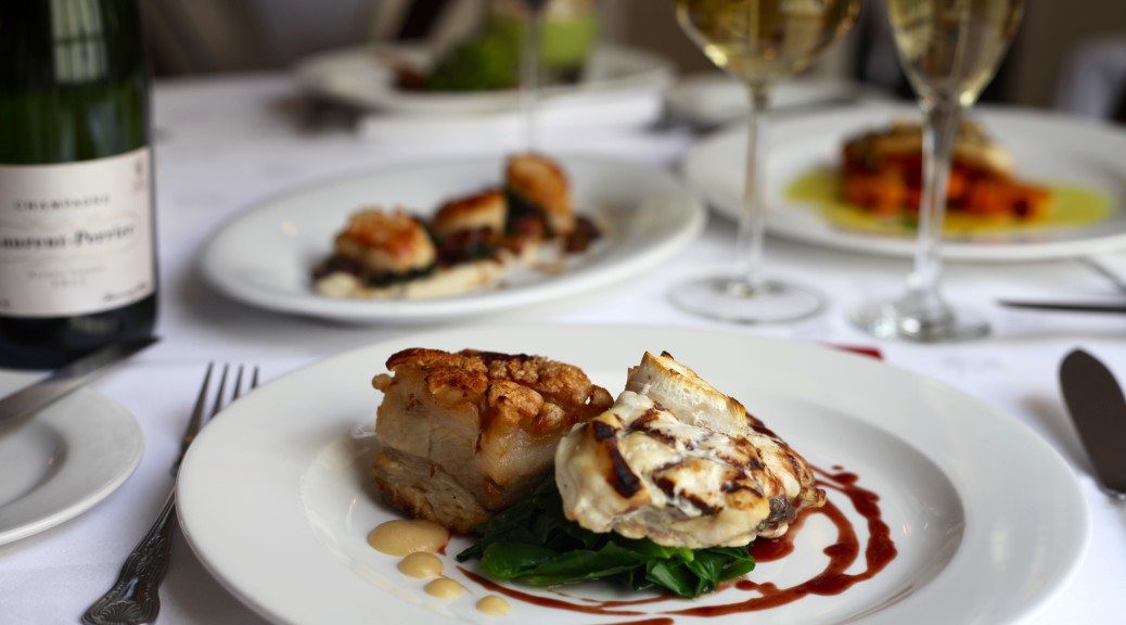 Table set with autumnal dishes and champagne