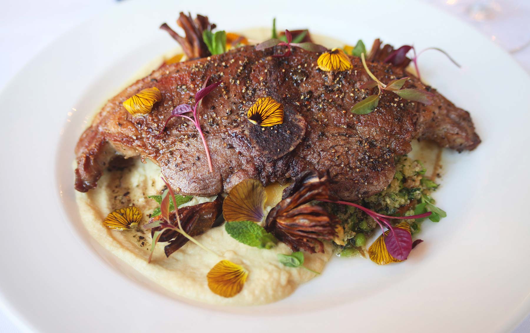 Spring lamb Barnsley chop, matured cheddar polenta, artichoke, pea salsa verde - t
